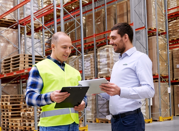 Two men discussing plans while in a Summit Companies warehouse