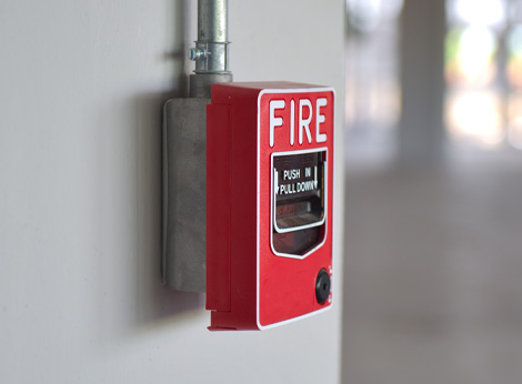 Red fire alarm on the wall