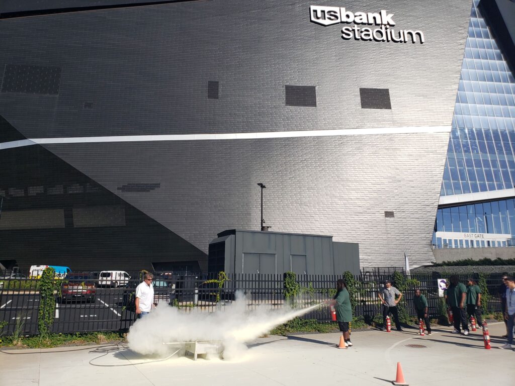 a fire extinguisher demonstration next to the U.S. bank stadium
