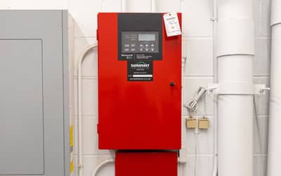 Red fire alarm control panel installed